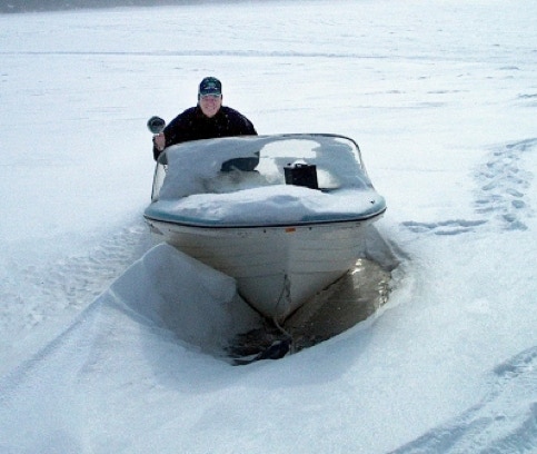 man in snow boat