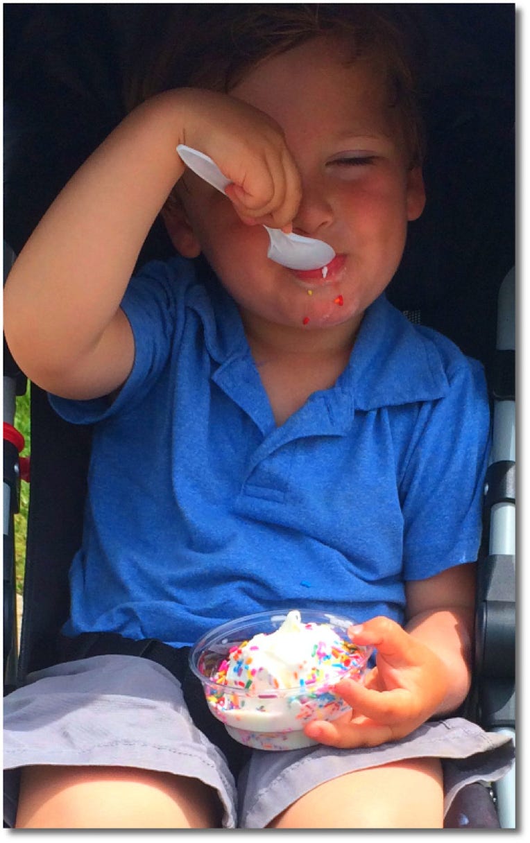 Kid eating sprinkle ice cream